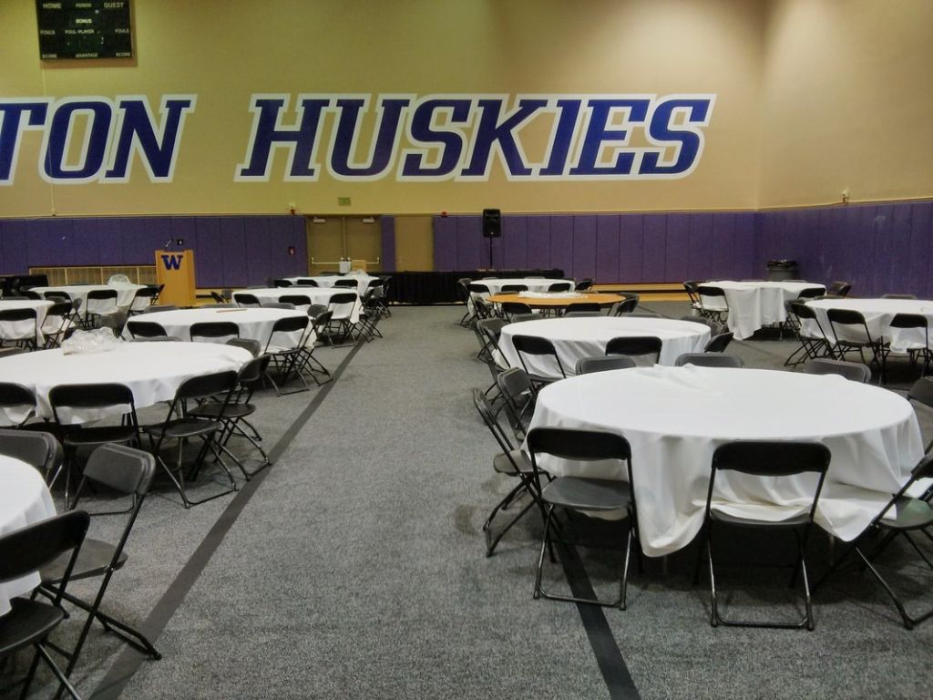 School gym set up for an event with tables